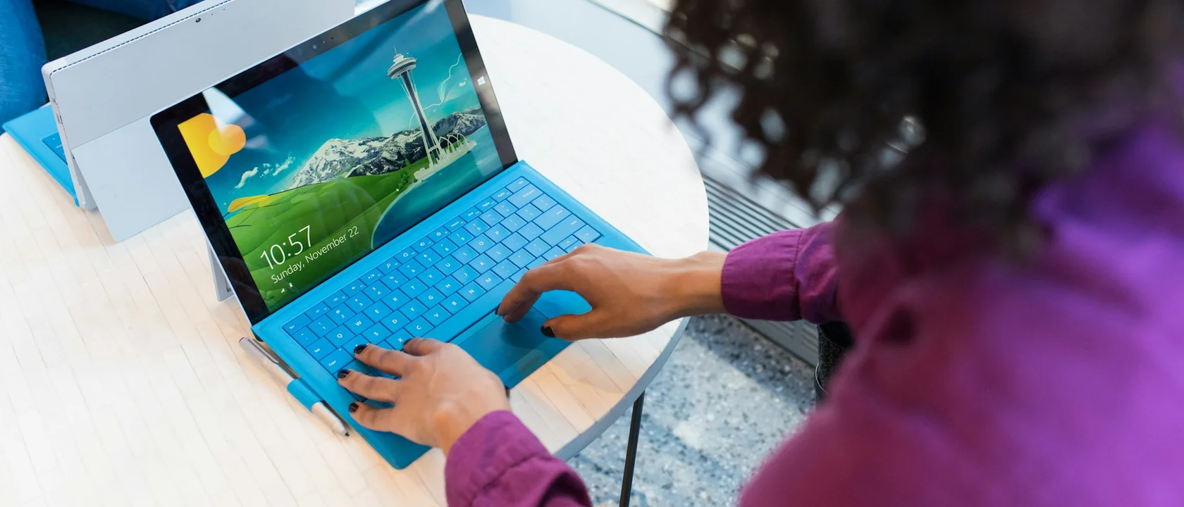 Person working on a laptop at a small table