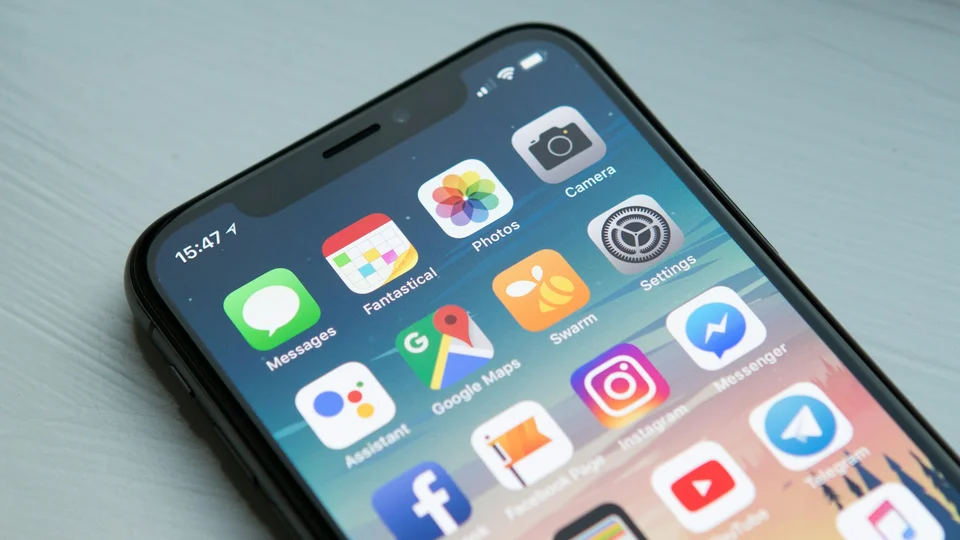 Person holding a smartphone with a business app on screen