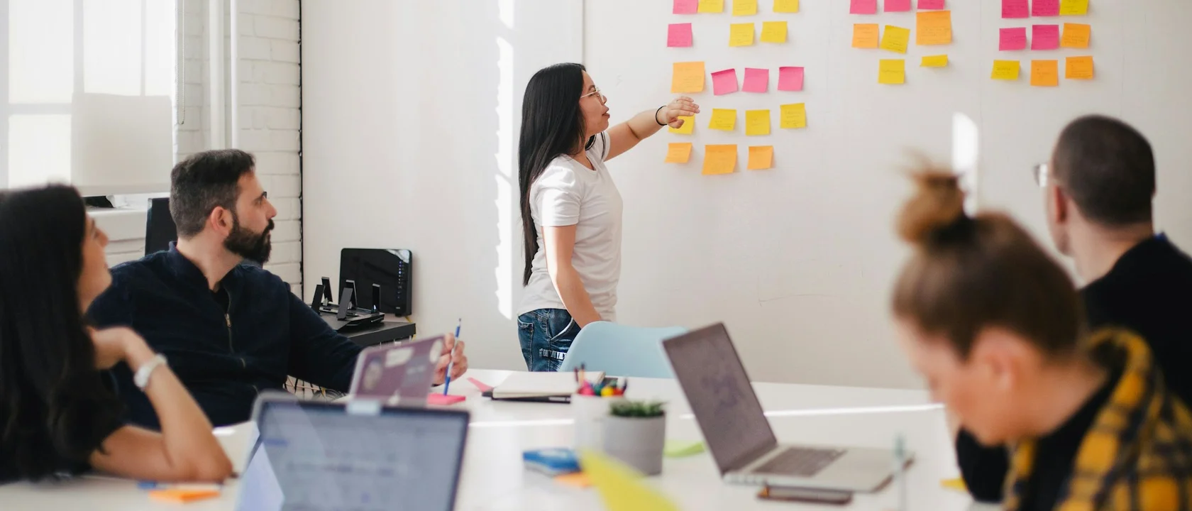 Developer reviewing mobile app wireframes on smartphone and laptop