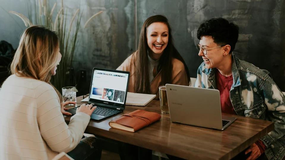 Business owner comparing smartphone app and browser dashboard side by side